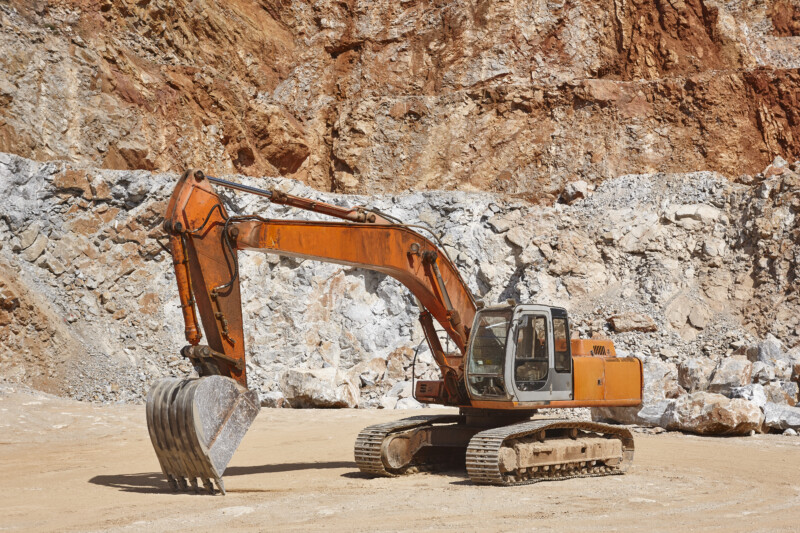Heavy excavator on a quarry. Excavation machinery. Earthmover wo Heavy excavator on a quarry. Excavation machinery. Earthmover